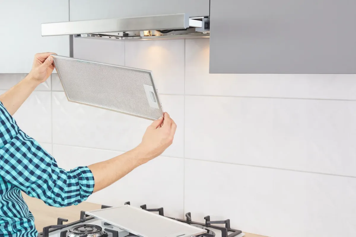 Range hood fan being diagnosed above a kitchen stove