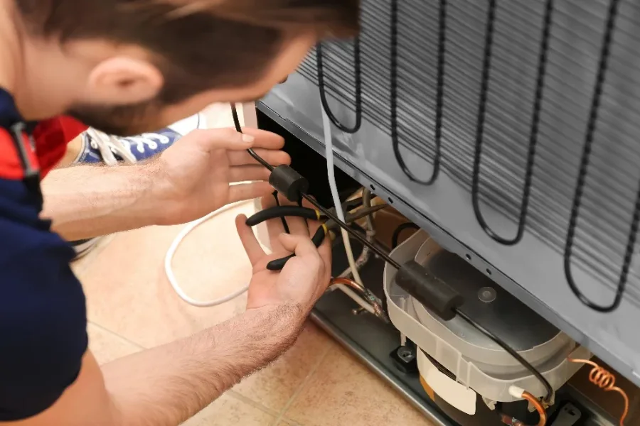 Refrigerator thermal fuse being replaced