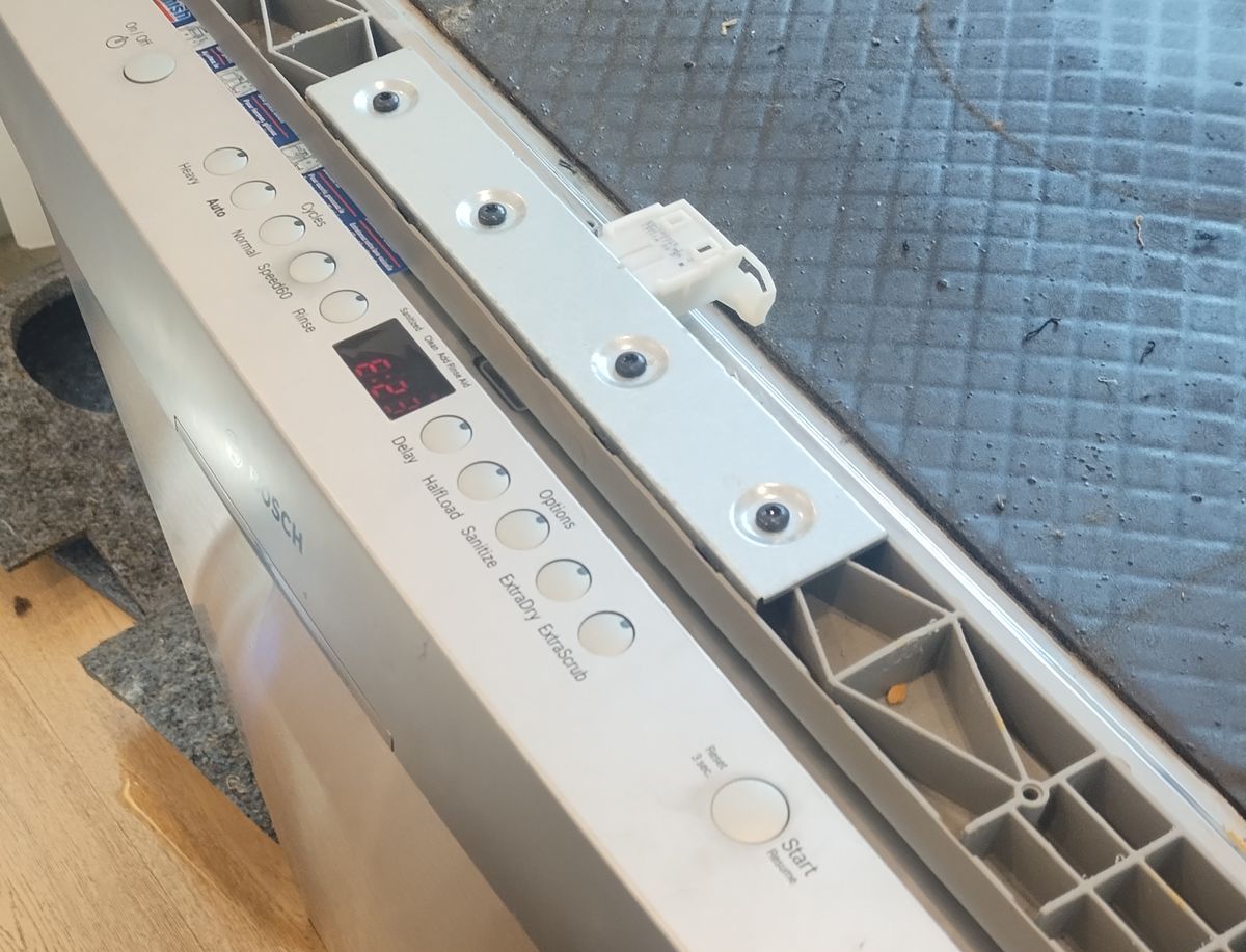Control panel of a Bosch SilencePlus dishwasher with the door open, showing E23 in red on the display